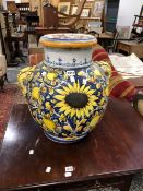 A MAJOLICA TWO HANDLED VASE PAINTED ON ONE SIDE WITH A SUNFLOWER AND LEMONS ON A BLUE GROUND. H