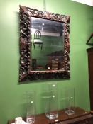 A BEVELLED GLASS RECTANGULAR MIRROR WITHIN A PIERCED AND CARVED OAK FOLIATE FRAME. 115 x 93cms.