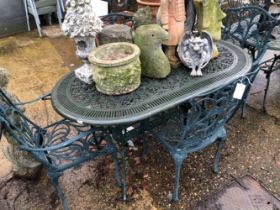 A SET OF FOUR GREEN PAINTED CAST ALLOY PATIO CHAIRS AND A SIMILAR TABLE.