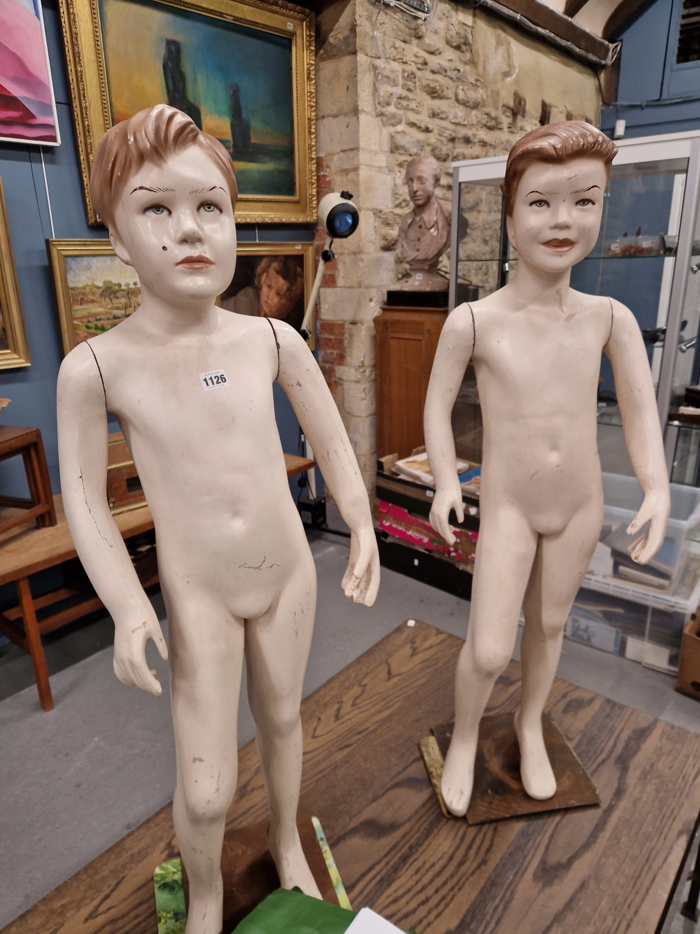 A PAIR OF MID 20th C. FIBRE GLASS AND METAL BOY MANNEQUINS STANDING ON SQUARE BASES. H 114cms.