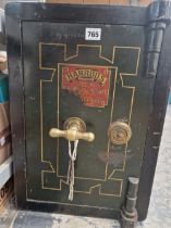 A SMALL ANTIQUE IRON SAFE LABELLED FOR HARRODS. C/W KEY. 36 X 36 X 51 cm.