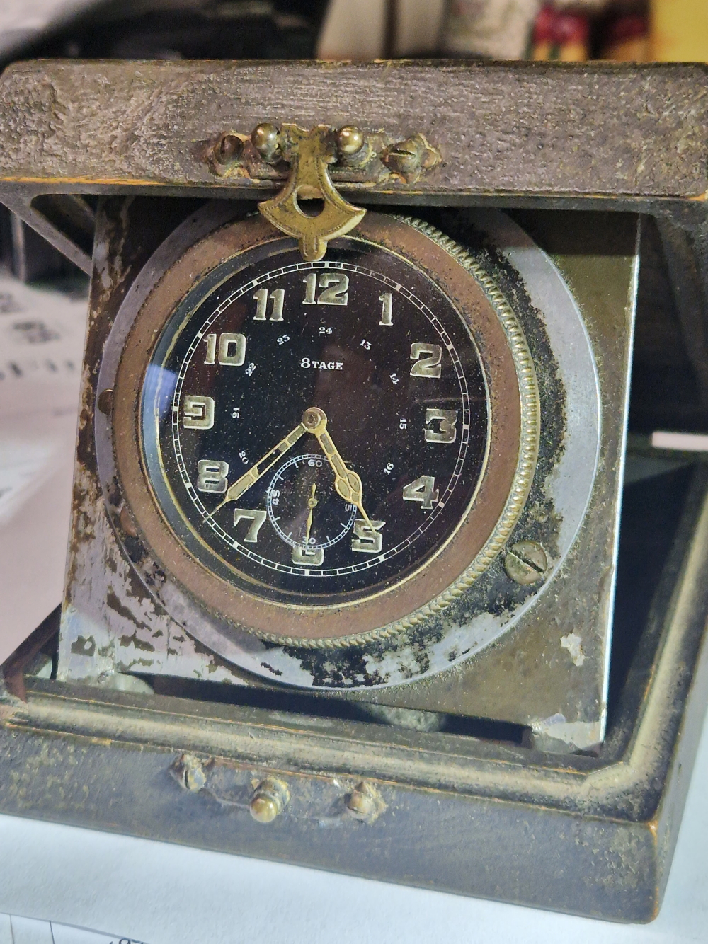 AN EARLY 20TH CENTURY AIRCRAFT OR CAR CLOCK. LATER MOUNTED IN A LIDDED BOX TOGETHER WITH CEAG COPPER
