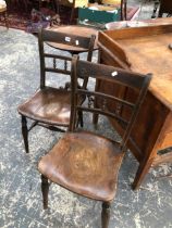 A PAIR OF OXFORD TYPE OAK CHAIRS WITH SADDLE SEATS AND THREE SPINDLES BETWEEN HORIZONTAL BARS TO THE