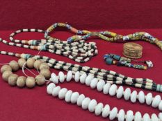 FIVE STRINGS OF VARIOUS GLASS BEADS, A LIMESTONE BEAD BRACELET TOGETHER WITH A NATIVE AMERICAN BIRCH