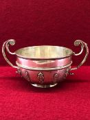 A SILVER TWO HANDLED BOWL BY S W SMITH & CO, LONDON 1900, BASALLY APPLIED WITH HUGUENOT STRAPWORK,