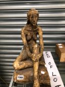 A PLASTER SCULPTURE OF A NUDE LADY SEATED