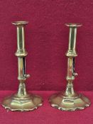 A PAIR OF LATE 18th/EARLY 19th C. BRASS CANDLESTICKS WITH EJECTOR RODS OPERATED BY PUSHERS ABOVE THE