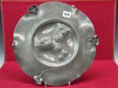 AN ART NOUVEAU PEWTER PLATE BY LUDWIG LICHTINGER (1878-1906) WITH THREE GROUPS OF THREE BERRIES ON