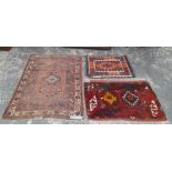 AN ANTIQUE PERSIAN AFSHAR RUG. 167 x 123cms TOGETHER WITH TWO TRIBAL BAG FACES (3)
