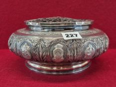 A BURMESE WHITE METAL 1960 PRESENTATION ROSE BOWL AND GRILLE COVER, THE BUN SHAPED SIDES WITH TOWN