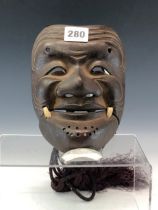 A JAPANESE IRON MASK WITH THE SEPARATE JAW TAPED TO THE CHEEKS, THE CHIN PIERCED TO TAKE A BEARD,