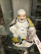 A CHINESE PORCELAIN SEATED FIGURE OF BUDAI