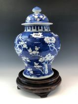 A CHINESE BLUE AND WHITE BALUSTER JAR, COVER AND WOOD STAND, THE PORCELAIN PAINTED WITH CHERRY