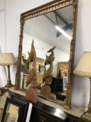 A LATE VICTORIAN RECTANGULAR MIRROR WITHIN A GILT FRAMED CLASSICALLY DETAILED IN BLACK THE