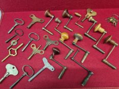 AN EXTENSIVE COLLECTION OF CLOCK KEYS TOGETHER WITH THREE PENDULUMS