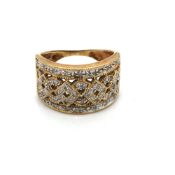 A DIAMOND SET OPEN WORK WIDE BAND RING. STAMPED 375, ASSESSED AS 9ct GOLD. FINGER SIZE L. WEIGHT 4.