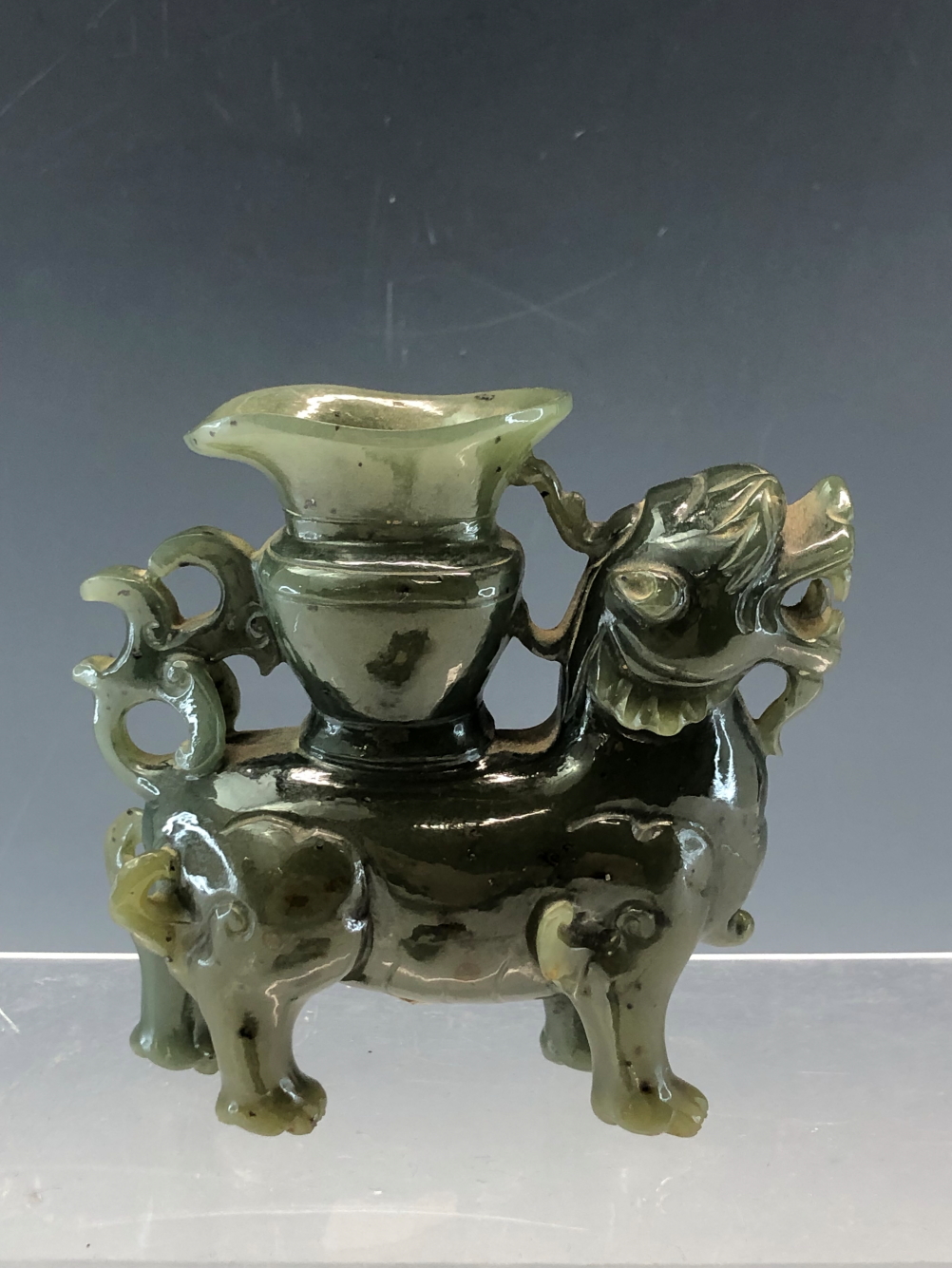 A CHINESE GREEN HARDSTONE FIGURE OF A QILIN WITH A VASE ON ITS BACK. W 11cms. TOGETHER WITH ITS - Image 4 of 4