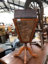 A CANED SIDED SEWING BASKET ON STAND