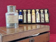 AN ARMY AND NAVY LEATHER MOUNTED PHARMACY CASE CONTAINING NINE LABELLED BOTTLES, THE CASE. W 21cms