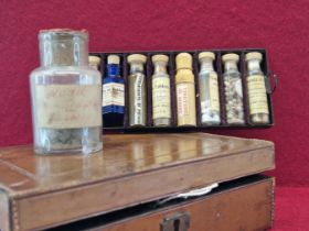 AN ARMY AND NAVY LEATHER MOUNTED PHARMACY CASE CONTAINING NINE LABELLED BOTTLES, THE CASE. W 21cms