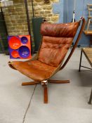A SIGURD RESELL BROWN LEATHER UPHOLSTERED FALCON CHAIR ON A BENT WOOD FRAME AND FOUR X-SHAPED LEGS