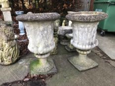 A PAIR OF LARGE GARDEN URNS DECORATED WITH CLASSICAL FIGURES ABOVE FLUTED SUPPORT AND SQUARE
