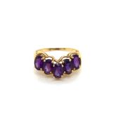 A FIVE STONE OVAL CUT AMETHYST WISHBONE RING. NO ASSAY MARKS, STAMPED 14K, ASSESSED AS 14ct GOLD.
