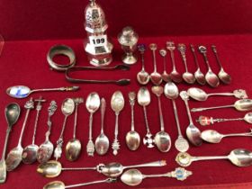 TWENTY TWO SILVER SOUVENIR TEA SPOONS, NINE OTHERS, A SILVER CASTER, A SILVER PEPPER, ETC.,