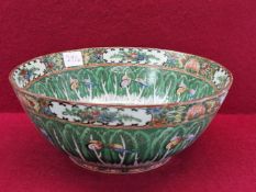A CANTON BOWL PAINTED WITH BUTTERFLIES AMONGST BANDS OF STIFF LEAVES. Dia 27.5cms.