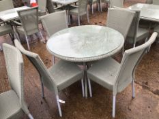 A CIRCULAR LLOYD LOOM PATIO TABLE AND 4 MATCHING CHAIRS.