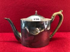 A GEORGE III SILVER TEA POT BY JOHN EMES, LONDON 1799, THE OVAL SECTIONED SHAPE WITH A BROWN HANDLE,