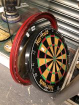 A DARTS BOARD, AN OVAL MIRROR AND TWO RAPIERS