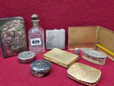 TWO SILVER CIGARETTE CASES, TWO SILVER LIDDED DRESSING TABLE ITEMS, AN ENGRAVED SCENT BOTTLE, A GILT