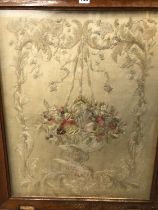 AN OAK FRAMED GREY TEXTILE PANEL SEWN IN WOOL WITH A BOWL OF FLOWERS SUSPENDED AND FRAMED BY FURTHER