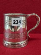 A GEORGE III SILVER MUG, LONDON 1773, THE FLARED CYLINDRICAL SIDES WITH TWO REEDED BANDS, 303Gms.