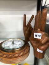 A WALL BAROMETER AND THREE CARVED HANDS