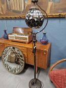 A TIFFANY STYLE STANDARD LAMP WITH LEADED GLASS GLOBE FORM SHADE.