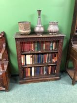 A LATE 19th C. OAK OPEN BOOKCASE, THE THREE SHELVES WITHIN GUILLOCHE CARVED PILASTERS ABOVE THE