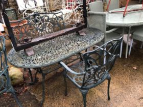 A GREEN PAINTED CAST ALLOY PATIO TABLE WITH MATCHING BENCH AND CHAIR.