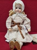 A SCHOENAU & HOFFMEISTER 1090 BISQUE HEADED DOLL WITH SLEEPING EYES AND OPEN MOUTH. H 44cms.