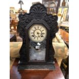 AN ANSONIA CLOCK STRIKING ON A COILED ROD AND WITHIN A GLAZED STAINED WOOD CASE. H 56cms.