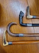 AN EBONISED WALKING STICK WITH A SILVER BAND BELOW THE HORN HORSES HOOF HANDLE, ANOTHER WALKING