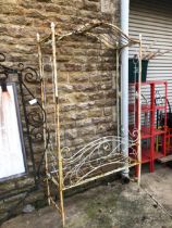 A VINTAGE PAINTED IRON GARDEN ARBOUR SEAT.