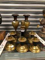 A SET OF FIVE BRASS CANDLESTICKS WITH BLACK FLUTED COLUMNS ANOTHER CANDLESTICK AND A PAIR OF ONYX