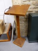 AN OAK LECTERN SUPPORTED ON A SQUARE COLUMN AND PYRAMIDAL FOOT