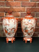 A PAIR OF JAPANESE KUTANI VASES AND COVERS, THE ELEPHANT HEAD HANDLED OVOID BODIES PAINTED WITH