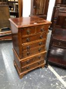 A PAIR OF 20th C. MAHOGANY BEDSIDE CHEST EACH WITH EIGHT DRAWERS CONFIGURED AS CHESTS ON CHESTS WITH