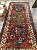 AN ANTIQUE CAUCASIAN KAZAK RUG. 272 x 127cms