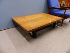 A TERENCE CONRAN ROLLER COFFEE TABLE, OAK RECTANGULAR PLATFORM ON FOUR RUBBER WHEELS, THE TOP. 120 x