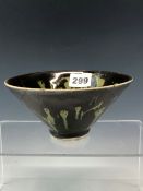 A CHINESE TRUNCATED CONICAL BOWL, THE TREACLE BLACK GLAZED SPLASHED AND STREAKED IN GREEN. Dia.14.